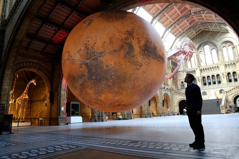 Artist Luke Jerram looks at his "Mars" installation at the Natural History Museum in London. Getty Images
