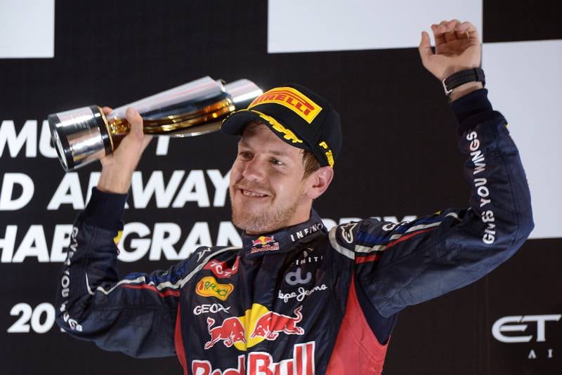 Red Bull Racing's German driver Sebastian Vettel  celebrates on the podium at the Yas Marina circuit on November 4, 2012 in Abu Dhabi after the Abu Dhabi Formula One Grand Prix. AFP PHOTO / DIMITAR DILKOFF
 *** Local Caption ***  818807-01-08.jpg