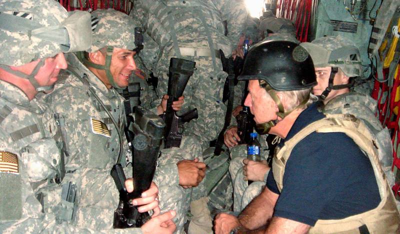 U.S. Senator and Democratic presidential candidate Joe Biden talks with soldiers as he travels in a military vehicle to Iraq from Kuwait in this September 6, 2007. Reuters