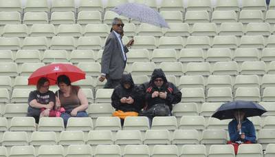 Spectators wait for the match to resume after rain disrupted play during the ICC Champions Trophy Group A match between Australia and New Zealand at Edgbaston in Birmingham, England. Rui Vieira / AP Photo