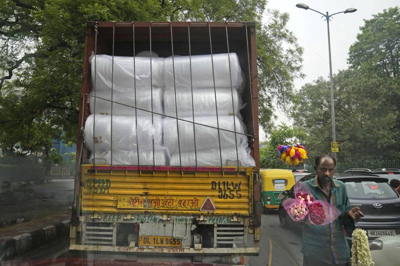 A lorry carries rolls of plastic used in packaging in New Delhi. AP
