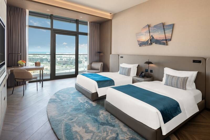 Floor-to-ceiling windows offer views of the Dubai skyline.