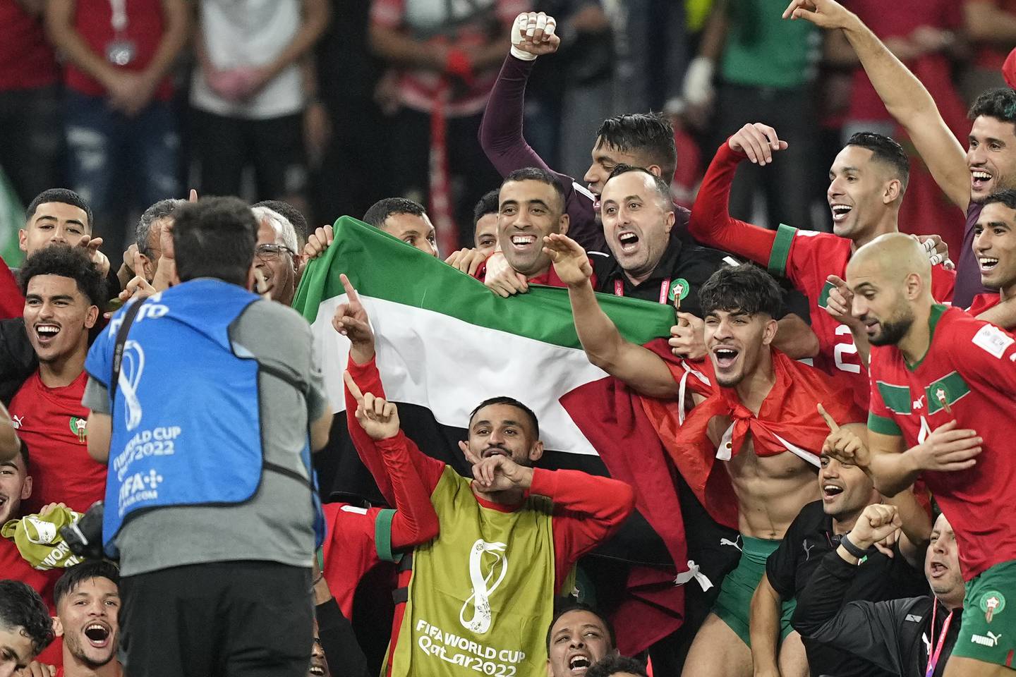 Morocco's players with the Palestinian flag after beating Spain. AP