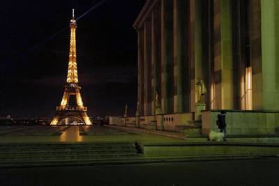 A woman walks her dog on the empty Trocadero, near the Eiffel Tower, during a curfew. AP