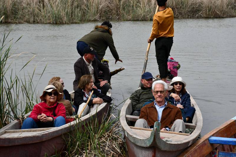 Spanish visitors of the Marshes of Jabayesh in southern Iraq tour the area by boat.