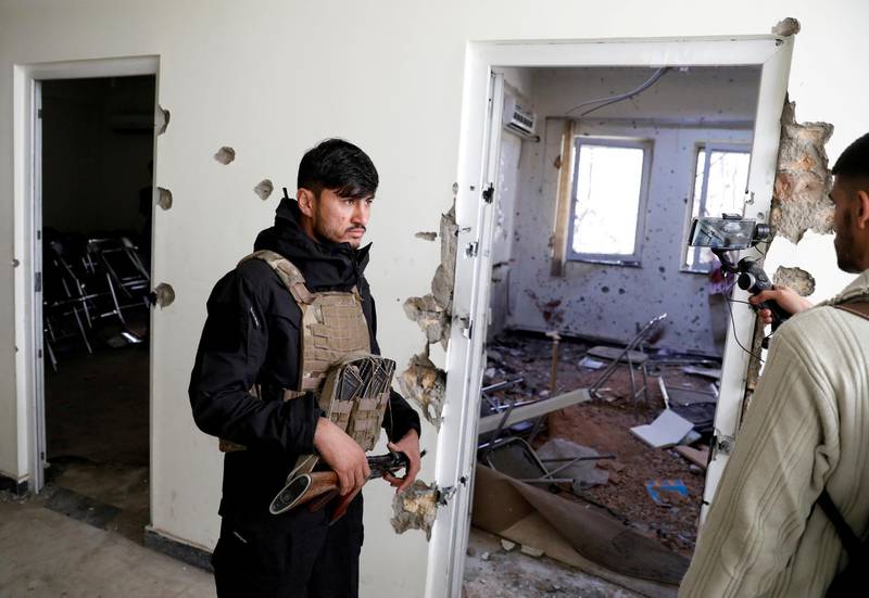 An Afghan policeman inspects the site after yesterday's attack at the university of Kabul. Reuters