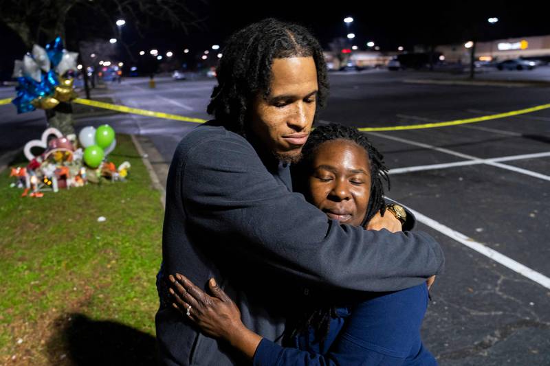 People visit a memorial for a shooting at a Walmart in Chesapeake, Virginia, in which seven people, including the gunman, were killed. Getty Images / AFP