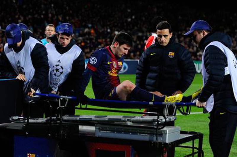 Barcelona's Lionel Messi is stretchered off against Benfica.