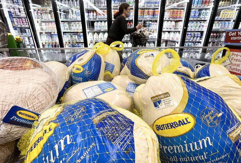 A shopper walks past turkeys displayed for sale in a grocery store ahead of the Thanksgiving holiday in Los Angeles earlier in the month. AFP