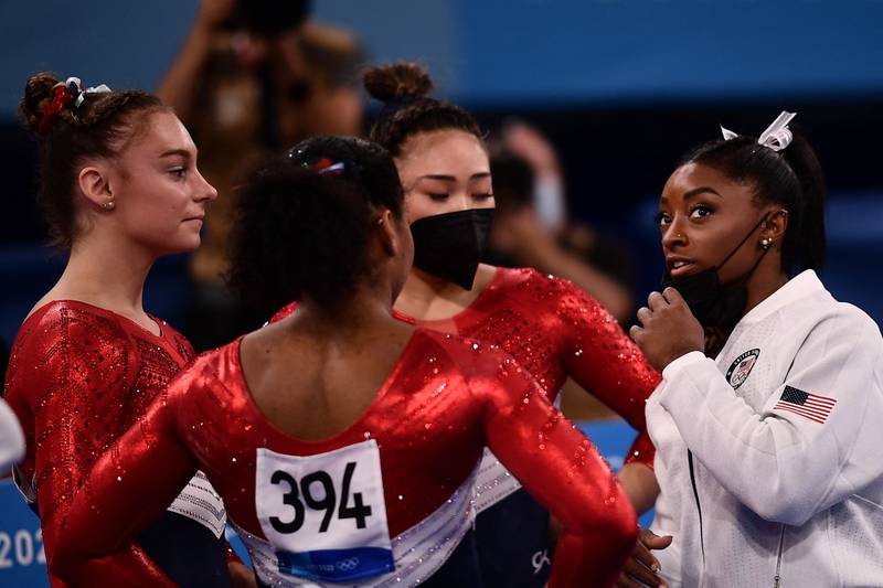 USA's Simone Biles speaks with her teammates during the artistic gymnastics women's team final.