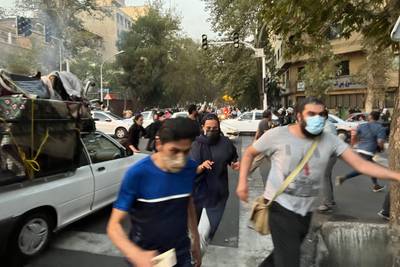 Demonstrators disperse during the protest for Amini, who died in a hospital in the capital Tehran on Friday. AFP
