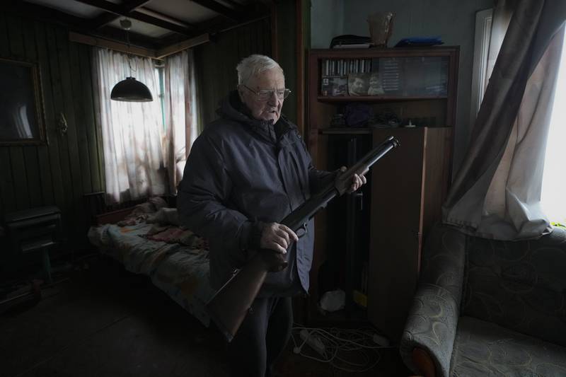 French teacher Pjotr Vyerko, 81, in his house which was damaged by the shock waves from a Russian air strike in Gorenka, outside Kyiv, on Wednesday. Vyerko told the Associated Press that he is prepared to use his rifle to shoot invaders because he has a daughter and grandson.  "If they come here, I'll jab them with a pitchfork if I don't have weapons – but I do have weapons," he said. AP Photo