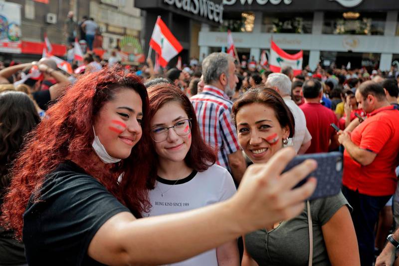 Lebanese demonstrators take a selfie during the protest. AFP