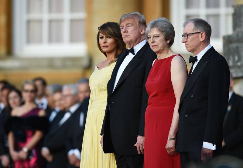 Britain's Prime Minister Theresa May and her husband Philip May greet US President Donald Trump and First Lady Melania Trump at Blenheim Palace on July 12, 2018 in Woodstock, England. Getty Images