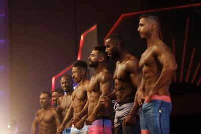 Participants pose during the Ashour Classic International Bodybuilding Championship on Saturday, March 19, 2022 in Tripoli, Libya.   The event was held for the first time in Libya, with the participation of 130 athletes.   (AP Photo / Yousef Murad)