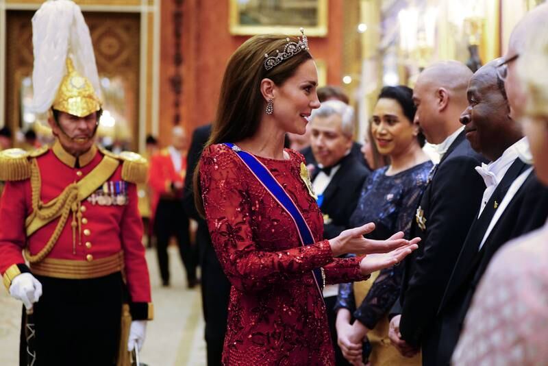 Kate speaks to guests at Buckingham Palace. Getty