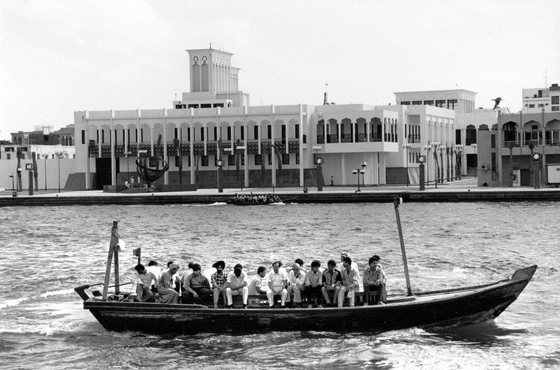 Dubai residents on an abra headed across Dubai Creek, with the diwan on the opposite side in Bur Dubai. Courtesy Richard Turpin, John R. Harris Library.