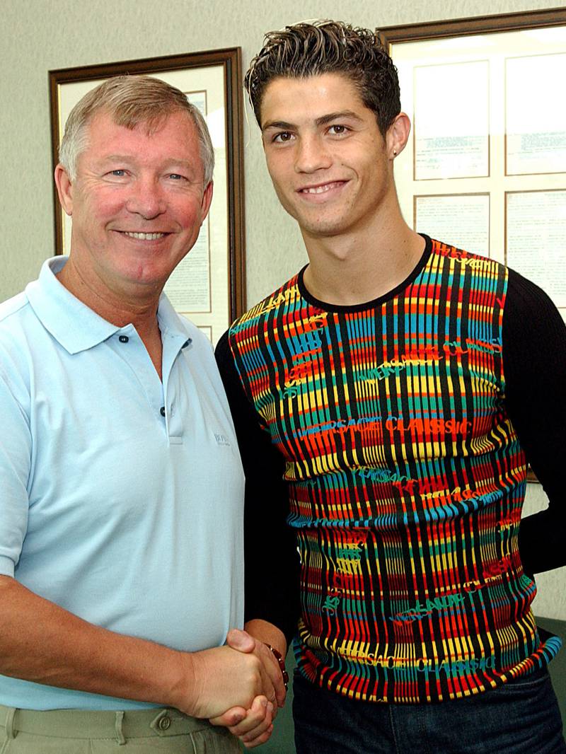 TOP 10 WORST FOOTBALL FASHION DISASTERS: No 10 - bookable offence: Cristiano Ronaldo sports a kaleidoscopic sweater as he is greeted by Sir Alex Ferguson after signing for Manchester United in 2003. Getty 