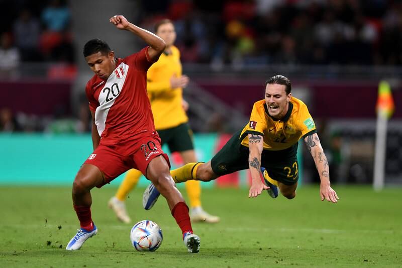 Edison Flores of Peru looks to control the ball as Jackson Irvine of Australia falls to the ground. Getty Images