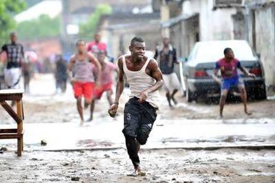 Abject poverty in Kinshasa, capital of the Democratic Republic of Congo, has spawned gangs of homeless young people who routinely rob shoppers and street vendors. Those who resist are often attacked with weapons. Above, a gang member flees from a rival group. Junior D Kannah / AFP