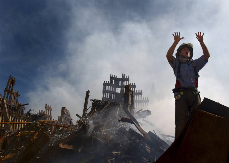 A New York City fireman calls for more rescue workers to make their way into the rubble of the World Trade Centre on September 15, 2001. Reuters