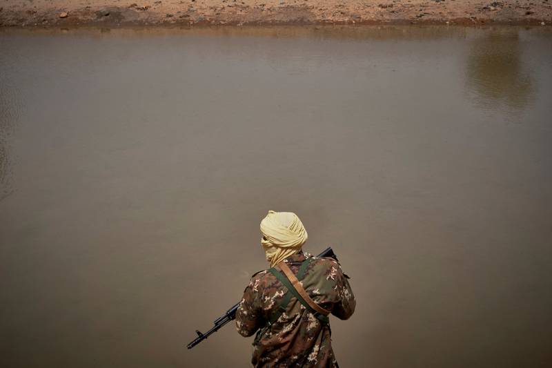 A Malian soldier patrols the river bank in Konna, central Mali. AFP