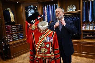 Tailor William Skinner with a ceremonial uniform on Savile Row, London, before the coronation of King Charles III and Queen Consort Camilla, on May 6. Reuters