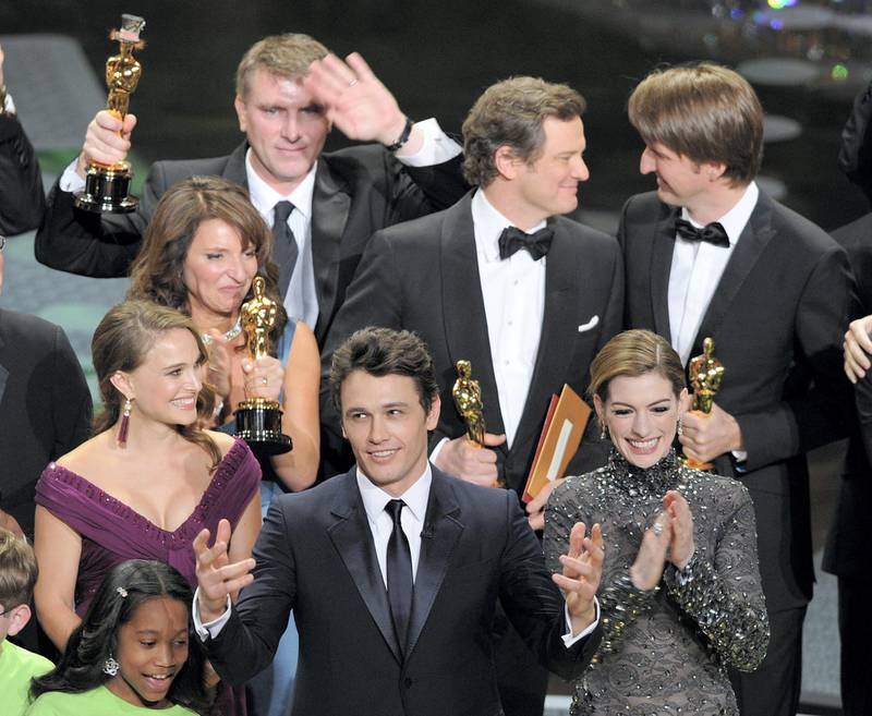 Actors and presenters James Franco (C) and Anne Hathaway (R) celebrate with the cast and crew of the Best Picture of the Year "The King's Speech" on stage after the 83rd Annual Academy Awards at the Kodak Theatre late on February 27, 2011 in Hollywood, California. AFP PHOTO / GABRIEL BOUYS (Photo by GABRIEL BOUYS / AFP)