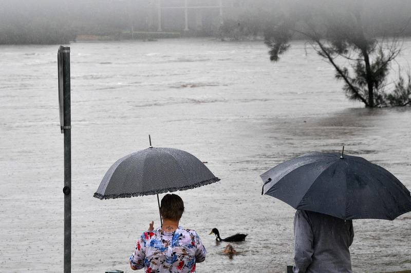 Residents look at the overflowing Nepean river in Penrith suburb. AFP