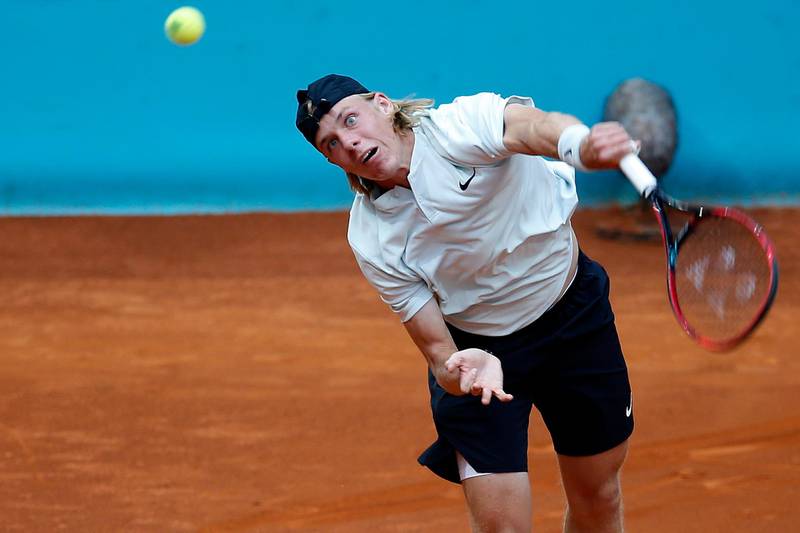 Denis Shapovalov, of Canada, returns the ball to Kyle Edmund, of Britain, during the Madrid Open tennis tournament in Madrid, Spain, Friday, May 11, 2018. (AP Photo/Paul White)