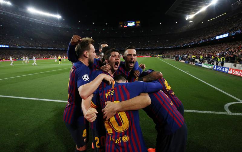 Lionel Messi celebrates scoring their second goal with Sergi Roberto and other teammates. Albert Gea / Reuters