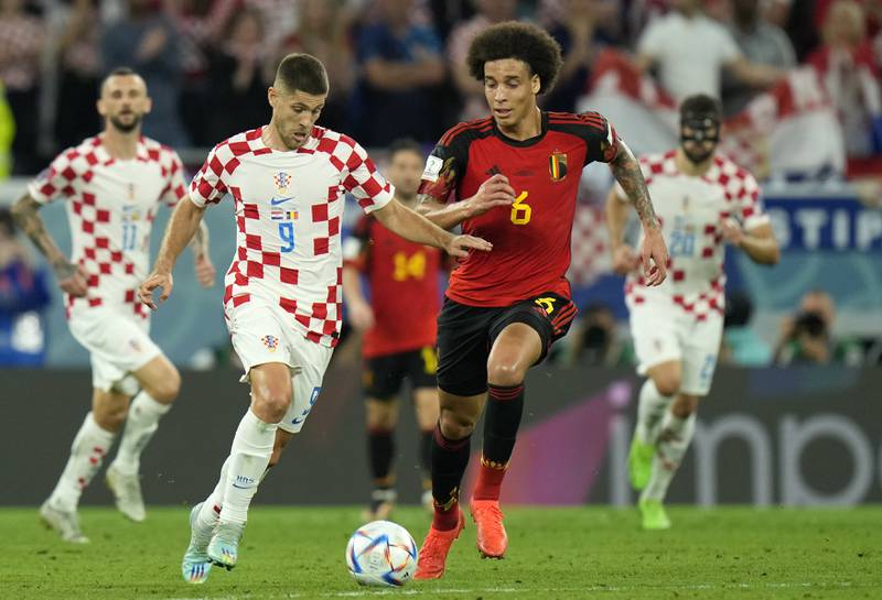 Croatia's Andrej Kramaric, left, duels for the ball with Belgium's Axel Witsel. AP