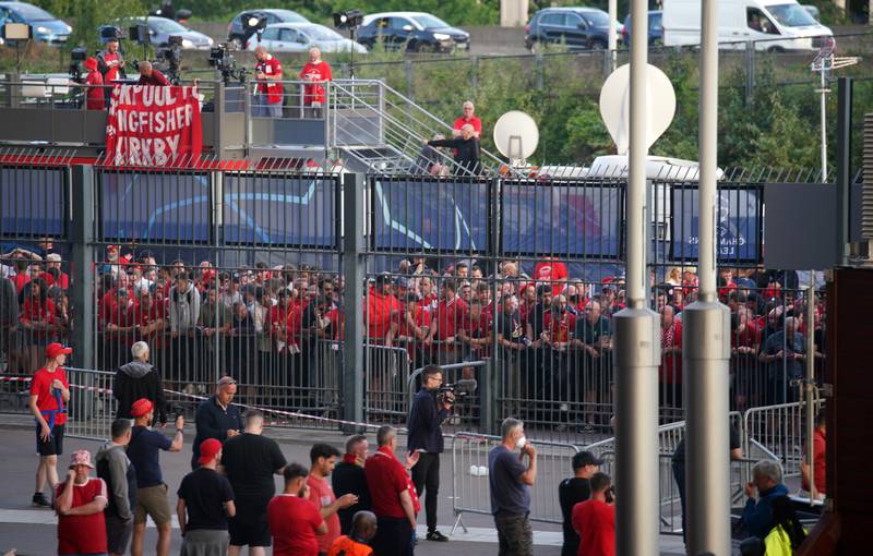 Liverpool fans queue to gain entry to the stadium. PA