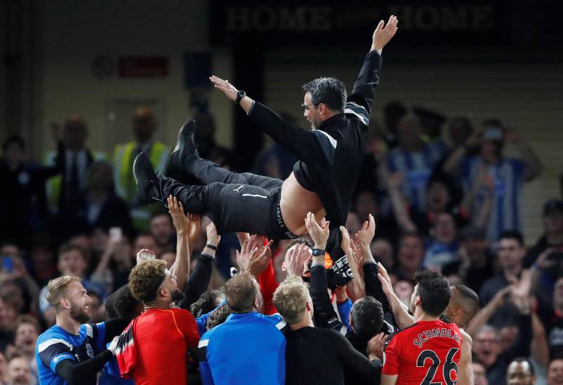 Soccer Football - Premier League - Chelsea v Huddersfield Town - Stamford Bridge, London, Britain - May 9, 2018   Huddersfield Town players throw manager David Wagner in the air as they celebrate staying in the Premier League after the match   Action Images via Reuters/Matthew Childs    EDITORIAL USE ONLY. No use with unauthorized audio, video, data, fixture lists, club/league logos or "live" services. Online in-match use limited to 75 images, no video emulation. No use in betting, games or single club/league/player publications.  Please contact your account representative for further details.
