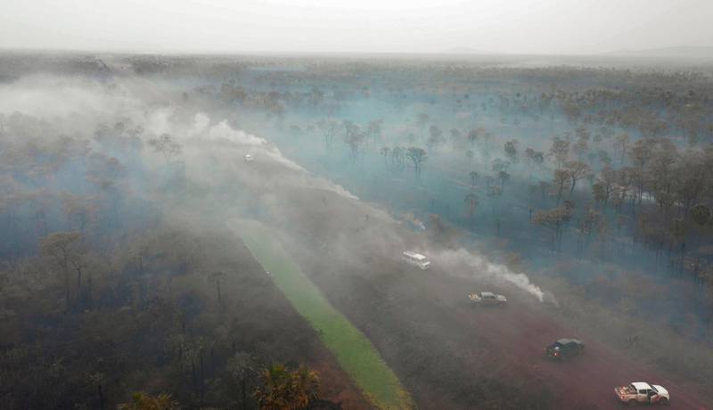 Aerial view of damage caused by wildfires in Otuquis National Park, in the Pantanal ecoregion of southeastern Bolivia, on August 26, 2019.  Like his far right rival President Jair Bolsonaro in neigboring Brazil, Bolivia's leftist leader Evo Morales is facing mounting fury from environmental groups over voracious wildfires in his own country. While the Amazon blazes have attracted worldwide attention, the blazes in Bolivia have raged largely unchecked over the past month, devastating more than 9,500 square kilometers (3,600 square miles) of forest and grassland. / AFP / Pablo COZZAGLIO

