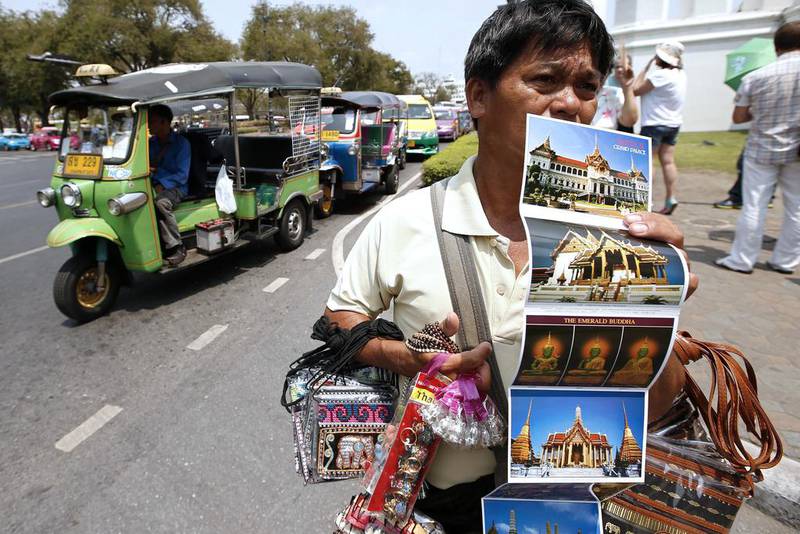 2nd: Bangkok. A Thai souvenir vendor waits for tourists at the entrance gate of the Grand Palace in Bangkok, Thailand. Rungroj Yongrit / EPA