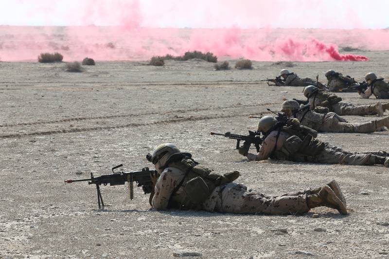 Soldiers test their marksmanship on a beach. Reuters