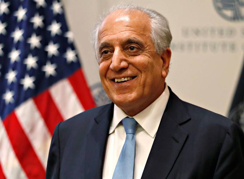 FILE - In this Feb. 8, 2019, file photo, Special Representative for Afghanistan Reconciliation Zalmay Khalilzad smiles at the U.S. Institute of Peace, in Washington. Khalilzad, U.S. peace envoy to Afghanistan, is in Beijing for a previously scheduled meeting, an American Embassy spokesman said Thursday, July 11, 2019, amid signs of new momentum in efforts to end Afghanistan's 17-year war and push by China to boost its influence in the region. (AP Photo/Jacquelyn Martin, File)