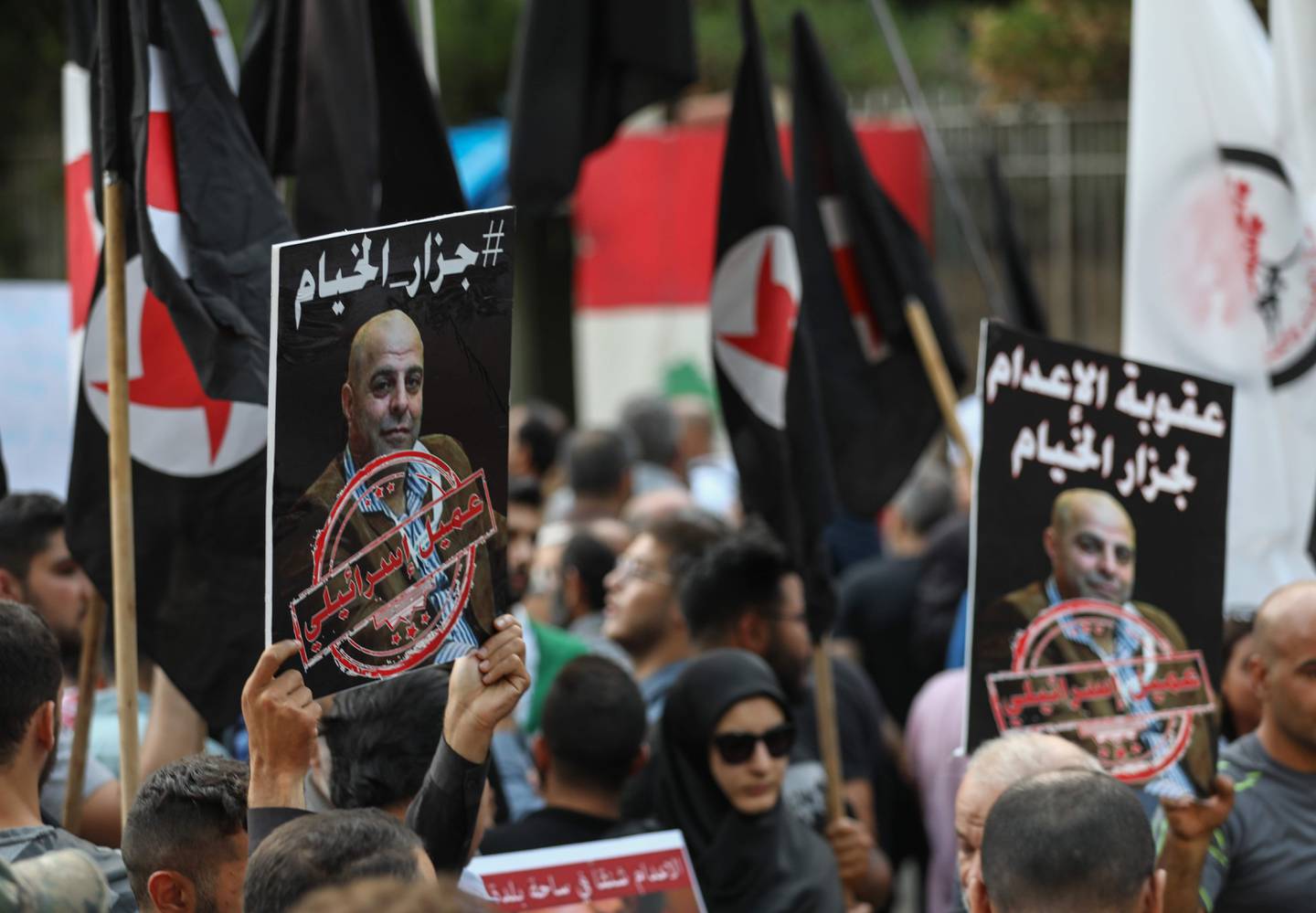 Former detainees of the pro-Israel South Lebanon Army (SLA) militia hold posters depicting former SLA member Amer al-Fakhoury during a demonstration denouncing his return and entry outside the Justice Palace in the Lebanese capital Beirut on September 12, 2019. Lebanon has detained Fakhoury, a senior warden in the notorious SLA-run Khiam prison, after his return to Lebanon from exile sparked widespread condemnation and accusations of torture, a judicial source said. Opened in 1984 in an Israeli-occupied security zone, the Khiam prison was run by the SLA under Israeli supervision during it's 22-year occupation of south Lebanon. / AFP / ANWAR AMRO 