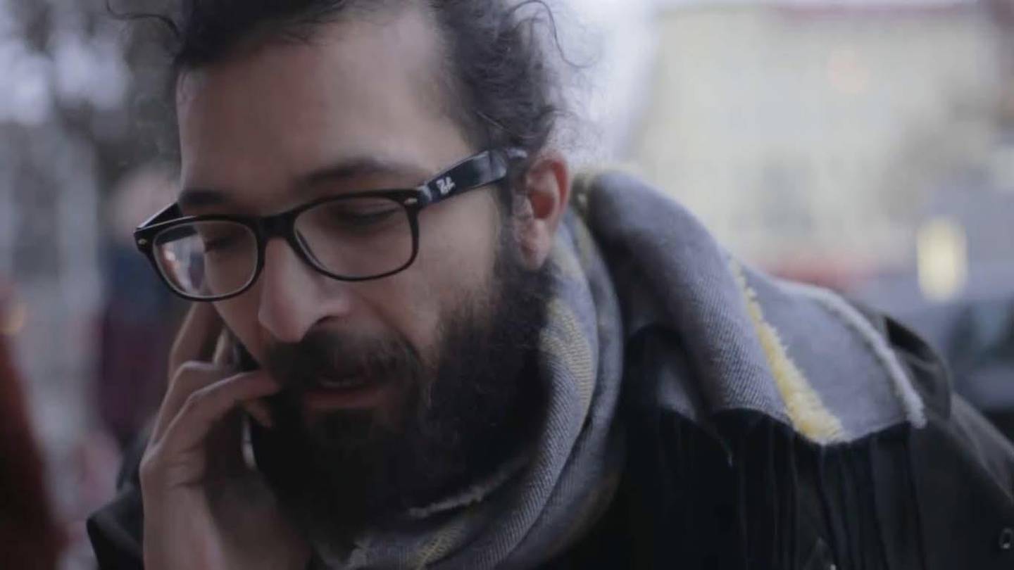 Ayham Majid Agha takes a call about a role in Berlin, where he works as an actor and playwright. Courtesy Nigol Bezjian 