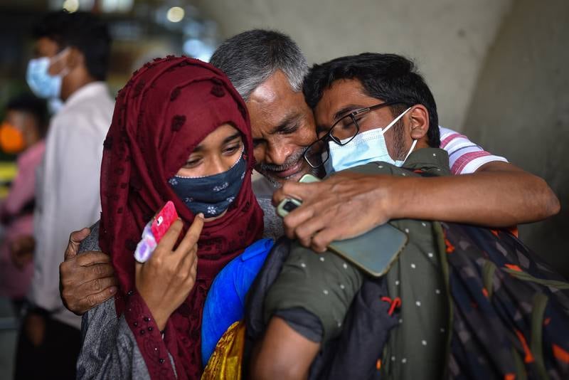 An Indian student is embraced by his family at Chennai Airport after returning from Ukraine. EPA