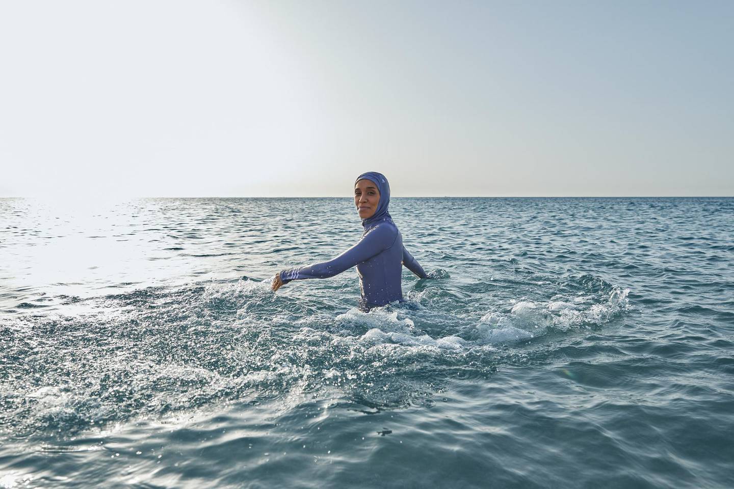 Adidas launches its first full coverage swimwear range, with a campaign starring Sudanese / British athlete and activist Asma Elbadawi. Courtesy Adidas
