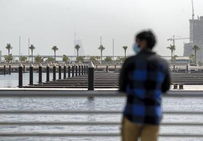 Dubai, United Arab Emirates - Reporter: N/A. Standalone. Weather. Covid-19/Coronavirus. A man looks out at the water with a face mask on a hazy day in Dubai. Wednesday, July 15th, 2020. Dubai. Chris Whiteoak / The National