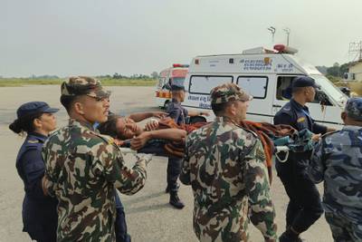 A woman airlifted from the earthquake zone is taken by stretcher for medical treatment, in Nepalgunj. AP