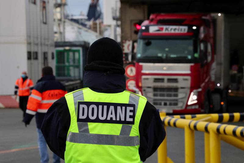 French customs officials monitor haulage trucks disembarking from a cross channel ferry from the UK at the Port of Calais in France. Bloomberg