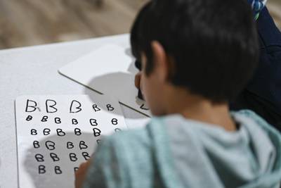 An Afghan pupil writes her ABCs during the first day of community-based education in Liberty Village, Joint Base McGuire-Dix-Lakehurst, New Jersey. Photo: Sgt Rion Ehrman / US Air Force