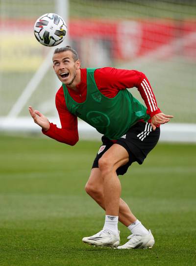 Gareth Bale lets his hair down during Wales' disappointing 1-1 draw with  Georgia - but is he again hiding a bald patch?