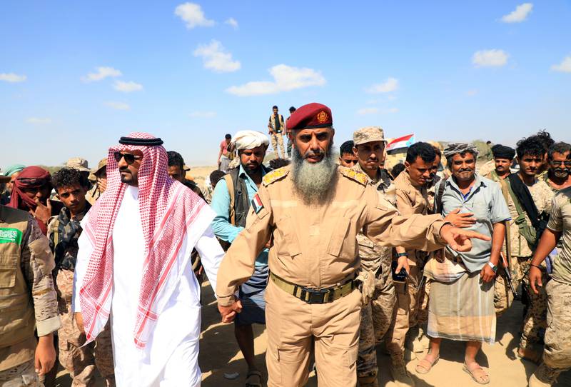 A Saudi officer walks with an army officer of Yemen's separatist Southern Transitional Council during the redeployment of STC forces from the southern Yemeni province of Abyan, Yemen. Reuters
