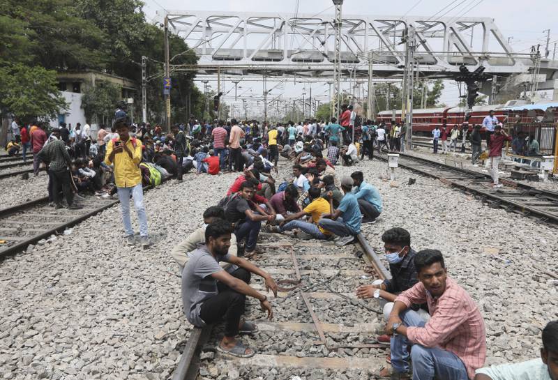 Protesters sit on railway tracks at Secunderabad station. AP