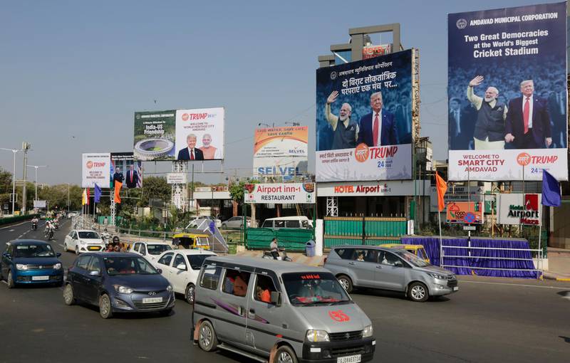Vehicles drive past hoardings welcoming  U.S. President Donald Trump in Ahmedabad, India, Saturday, Feb. 22, 2020. Trump is visiting the city of Ahmedabad in Gujarat during a two-day trip to India to attend an event called "Namaste Trump," which translates to "Greetings, Trump," at a cricket stadium along the lines of a "Howdy Modi" rally attended by Indian Prime Minister Narendra Modi in Houston last September. (AP Photo/Ajit Solanki)